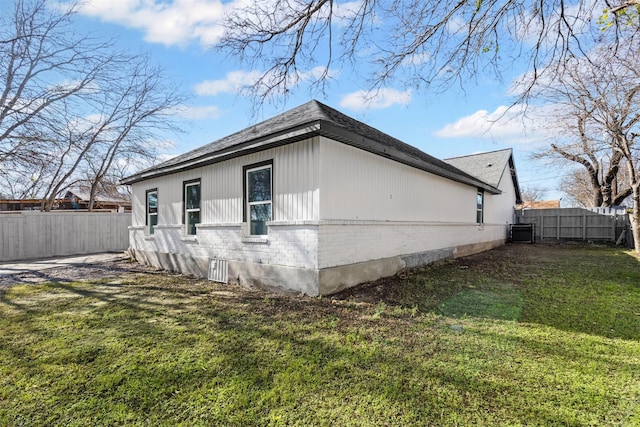 view of side of home featuring a yard