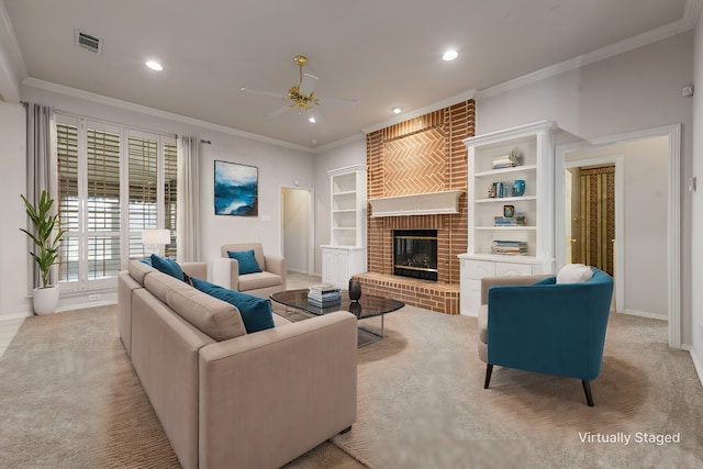 carpeted living room featuring built in shelves, ceiling fan, a fireplace, and ornamental molding