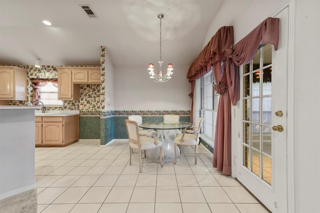 unfurnished dining area featuring light tile patterned floors and an inviting chandelier