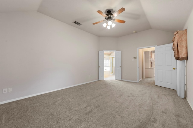 unfurnished bedroom featuring ceiling fan, light carpet, and vaulted ceiling