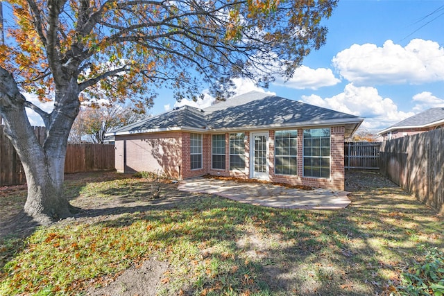 back of house featuring a yard and a patio