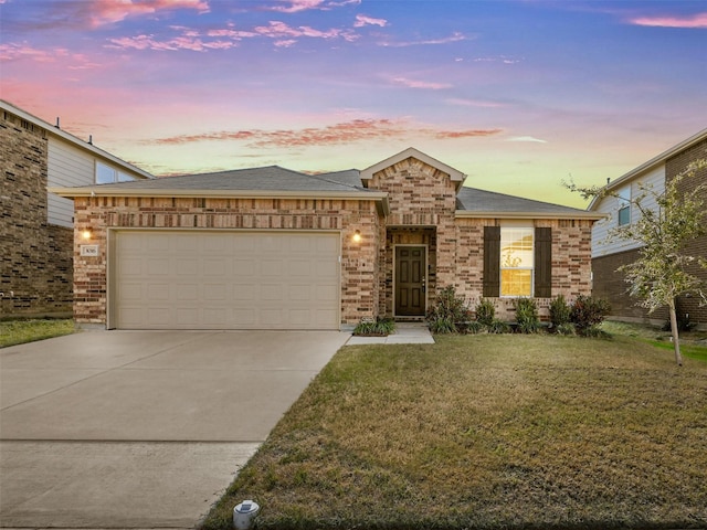 view of front of home featuring a garage and a lawn