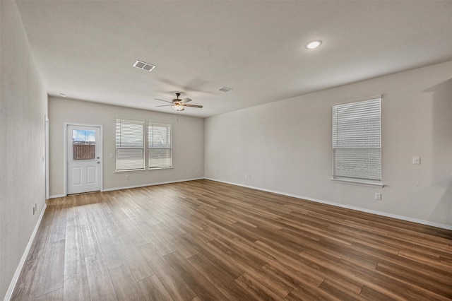 unfurnished room featuring dark hardwood / wood-style floors and ceiling fan