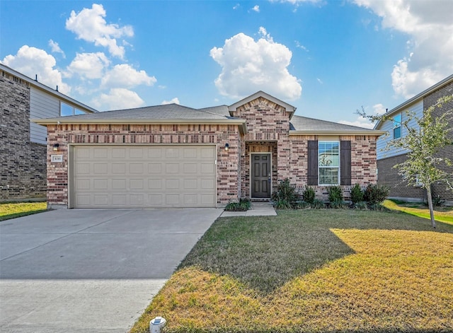 view of front of property featuring a garage and a front lawn