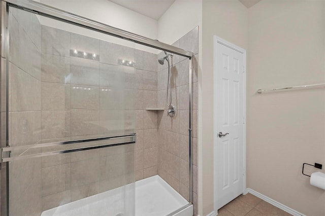 bathroom with tile patterned flooring and an enclosed shower