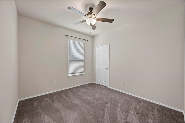 empty room featuring ceiling fan and dark carpet