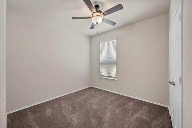 empty room with dark carpet and ceiling fan