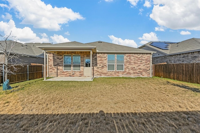 back of property featuring a yard and a patio