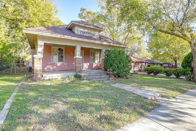 view of front of property with a porch and a front yard