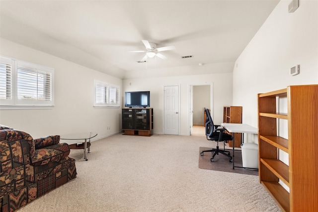 office with baseboards, carpet flooring, visible vents, and a ceiling fan