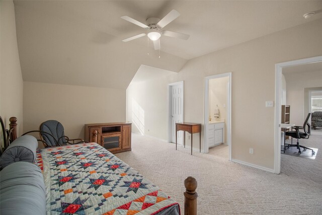 bedroom with light carpet, ensuite bath, ceiling fan, and lofted ceiling