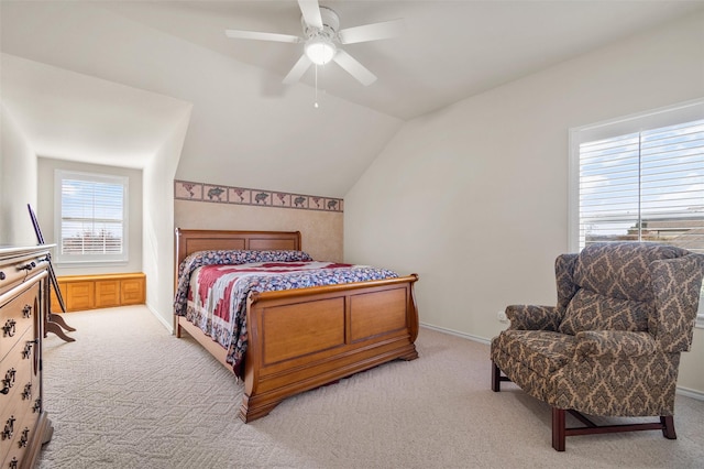 bedroom with ceiling fan, light carpet, and vaulted ceiling