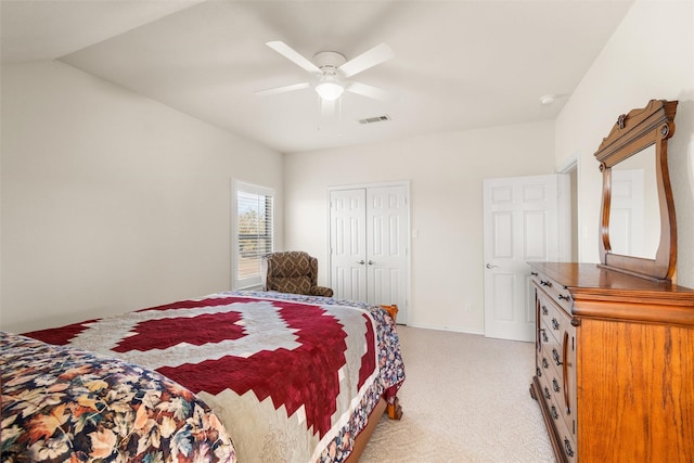 bedroom featuring a closet, light colored carpet, visible vents, ceiling fan, and baseboards