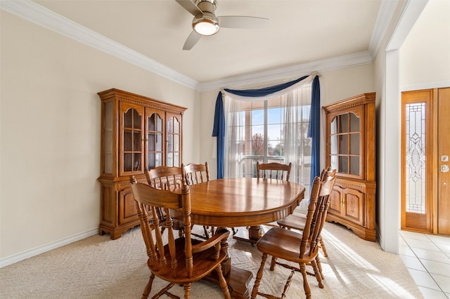 dining space featuring ceiling fan, light carpet, and ornamental molding