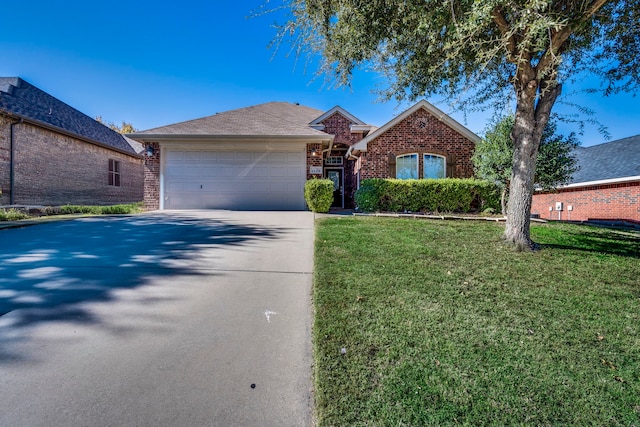 view of front of property with a garage and a front lawn