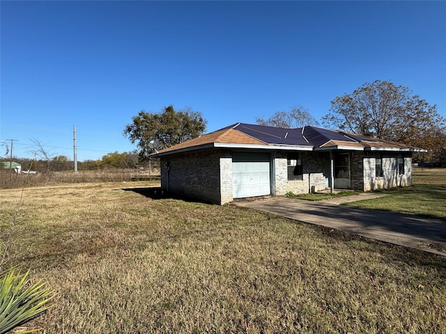 exterior space featuring a lawn and a garage