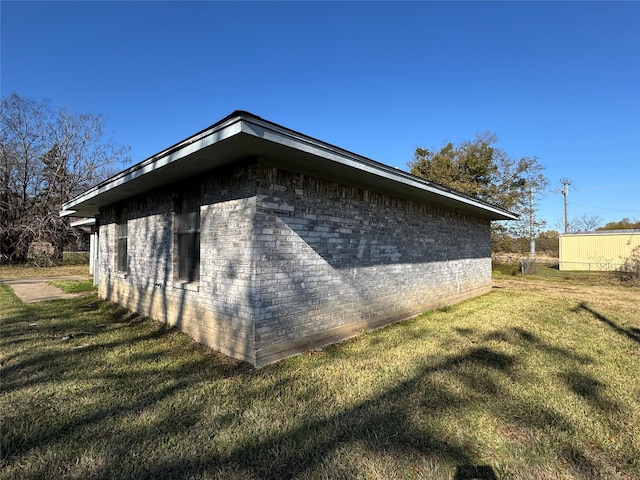 view of side of home featuring a lawn