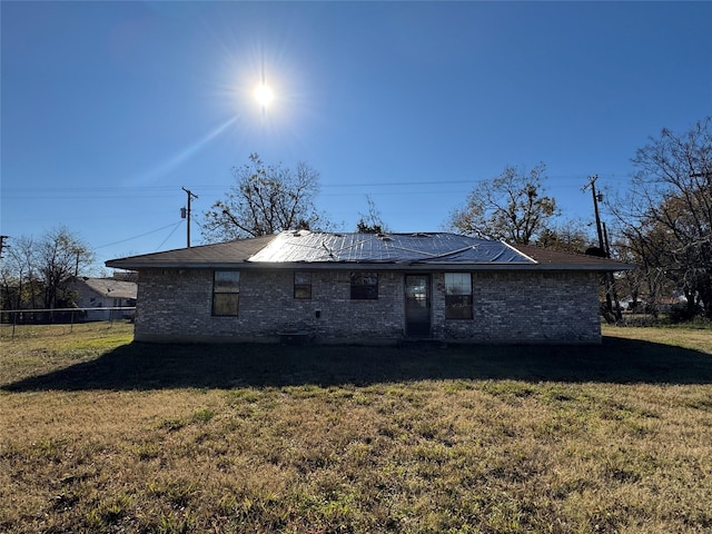 back of house featuring a lawn