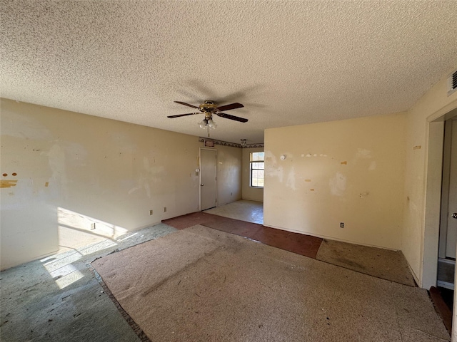 spare room featuring a textured ceiling and ceiling fan