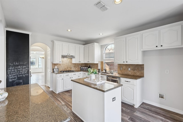 kitchen with white cabinetry, a kitchen island, and dark hardwood / wood-style floors