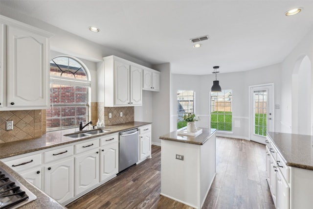 kitchen featuring dishwasher, white cabinets, and a kitchen island