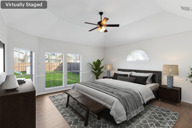 bedroom with dark hardwood / wood-style flooring, ceiling fan, and lofted ceiling