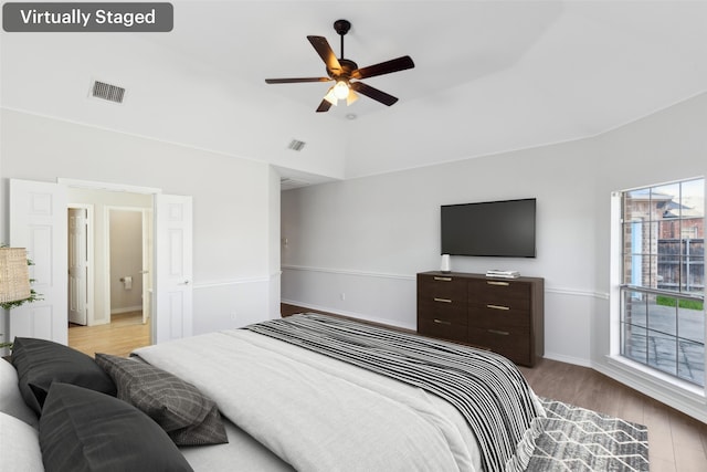 bedroom featuring ceiling fan, vaulted ceiling, and light hardwood / wood-style flooring