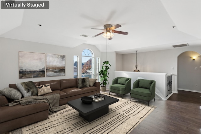 living room featuring a stone fireplace, ceiling fan, high vaulted ceiling, and wood-type flooring