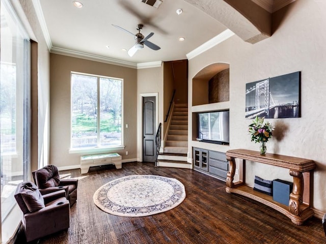 living room with wood-type flooring, ceiling fan, and ornamental molding