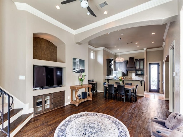 living room featuring crown molding, dark hardwood / wood-style flooring, and ceiling fan