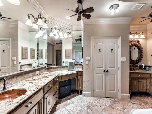 bathroom with vanity, ornamental molding, and tasteful backsplash