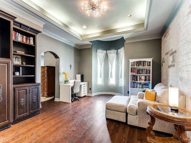 sitting room featuring a raised ceiling, crown molding, and dark wood-type flooring