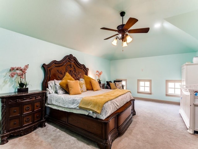 bedroom featuring ceiling fan, light colored carpet, and lofted ceiling