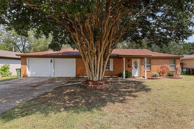 ranch-style house with driveway, an attached garage, a front yard, and brick siding