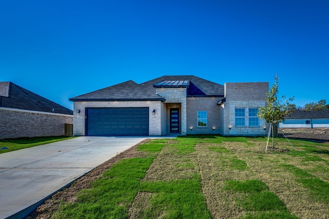 view of front facade with a garage and a front lawn