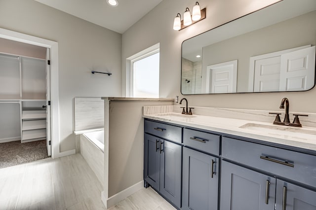 bathroom with vanity and separate shower and tub