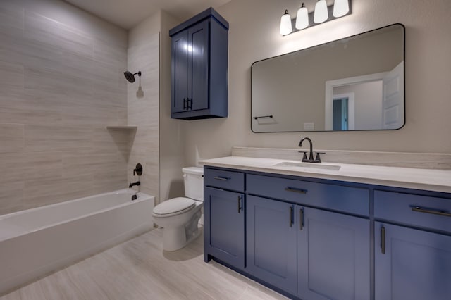 full bathroom with hardwood / wood-style floors, vanity, toilet, and tiled shower / bath combo