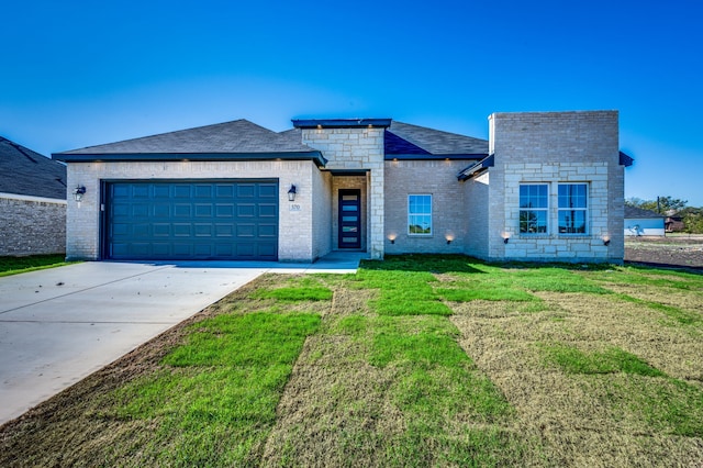 view of front facade with a front yard and a garage