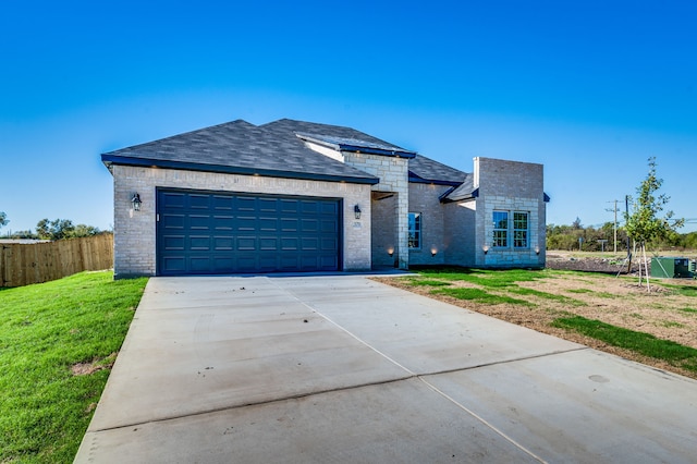 view of front of house with a garage and a front lawn