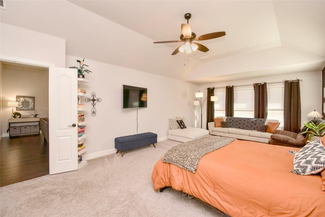 bedroom featuring vaulted ceiling, light carpet, and ceiling fan