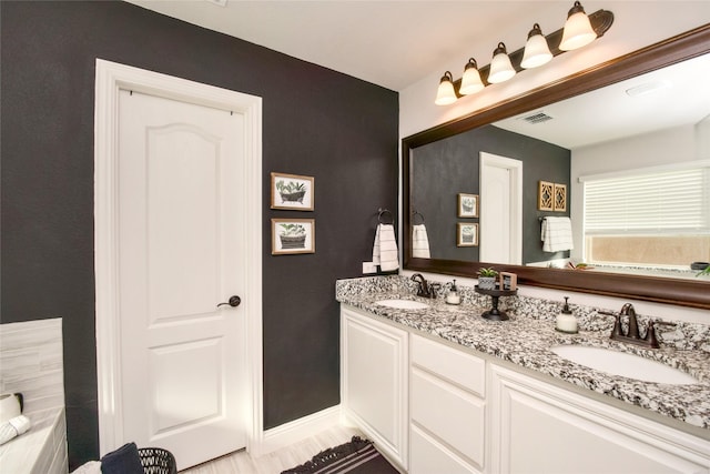 bathroom with vanity and hardwood / wood-style flooring