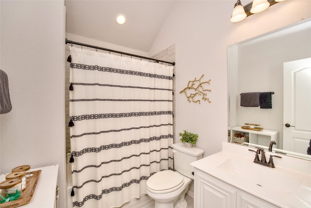 bathroom with a shower with curtain, lofted ceiling, toilet, and vanity