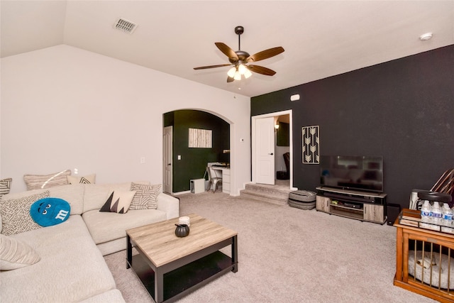 carpeted living room featuring ceiling fan and vaulted ceiling