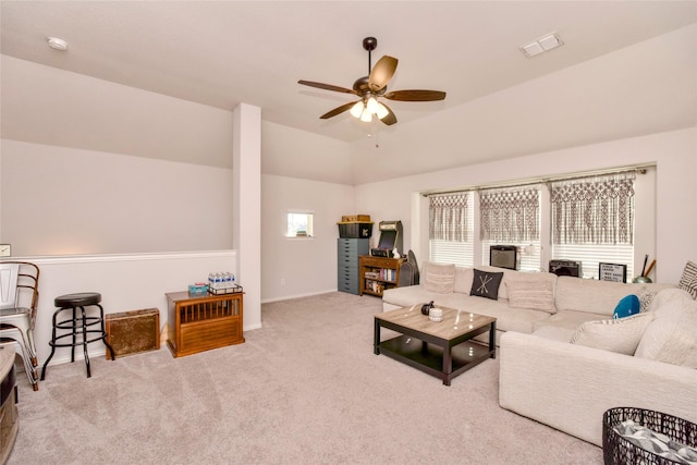 carpeted living room with a wealth of natural light, lofted ceiling, and ceiling fan