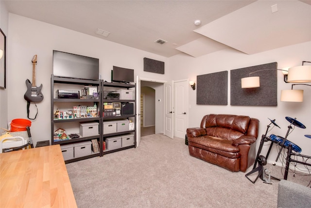 sitting room featuring light colored carpet