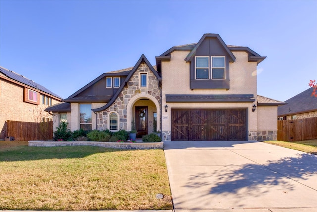 view of front of property with a garage and a front lawn