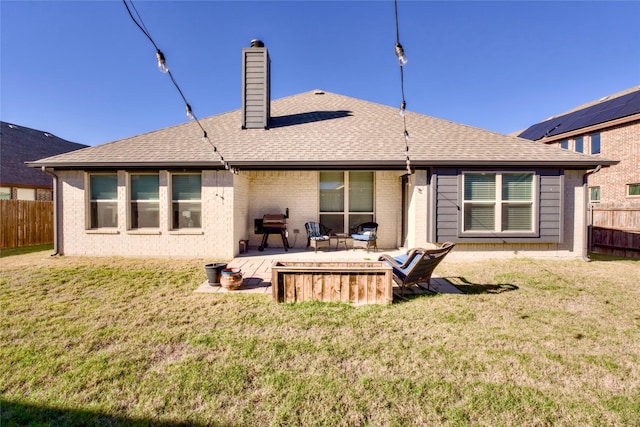 back of house with a yard and a patio