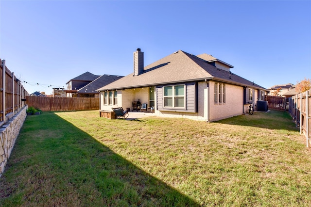 back of house featuring a yard, cooling unit, and a patio