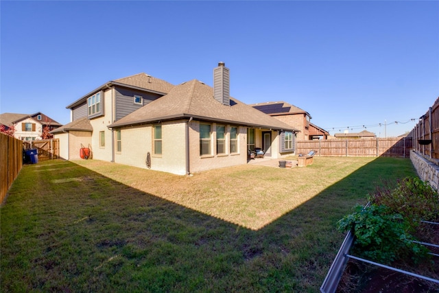 rear view of property with a patio and a lawn