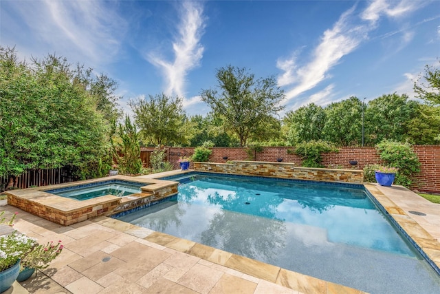 view of swimming pool with an in ground hot tub